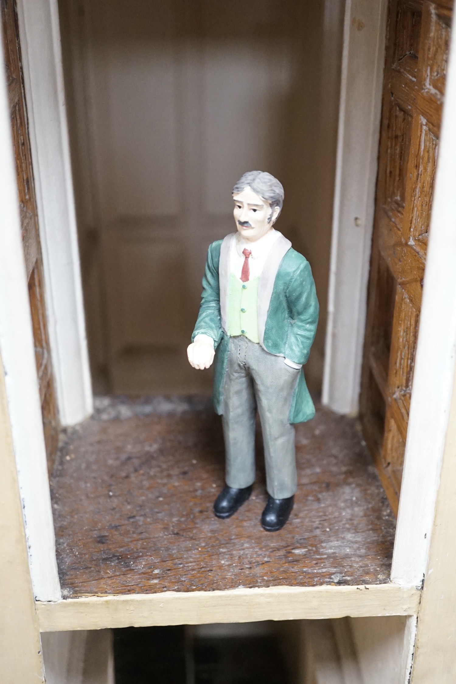 An early 19th century painted doll's house with block work facade enclosing a four room interior with central staircase, to be sold with assorted later furniture and accessories, width 117cm, depth 48cm, height with asso